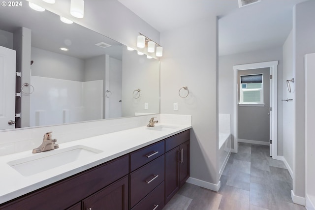 bathroom featuring vanity and shower with separate bathtub