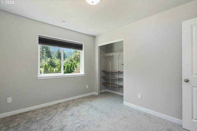 unfurnished bedroom with carpet and a closet