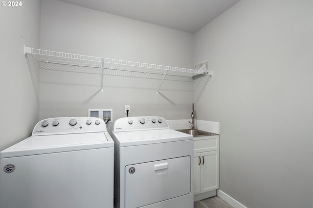 washroom featuring cabinets, washer and dryer, and sink