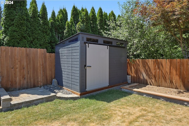 view of outbuilding with a lawn