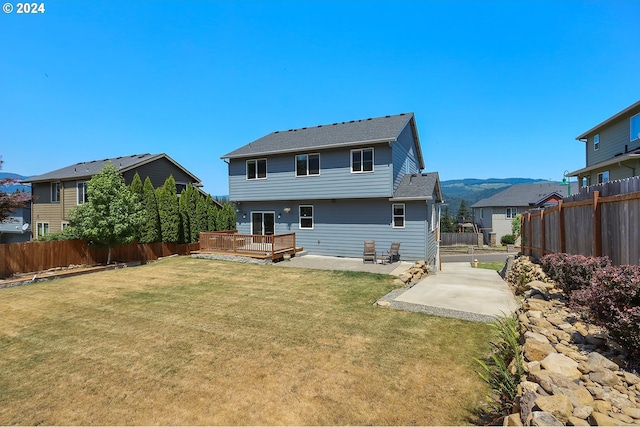 rear view of house with a patio area and a lawn