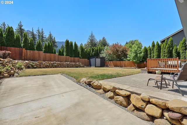 view of patio / terrace featuring a storage shed and a deck