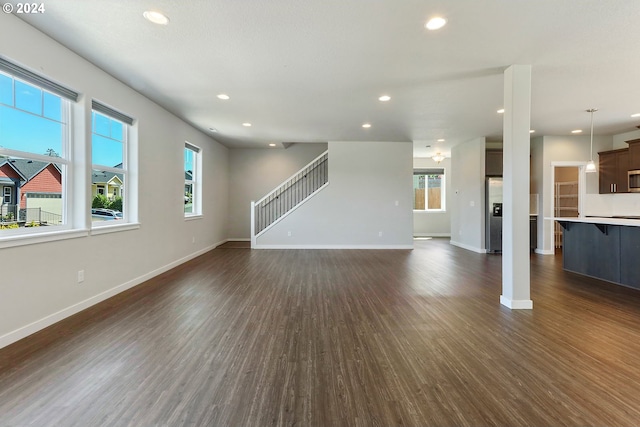 unfurnished living room with dark hardwood / wood-style floors