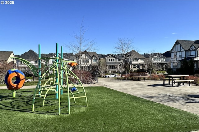 community play area with a yard and a residential view