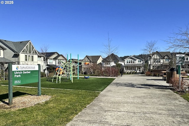 exterior space featuring a residential view, a lawn, and playground community