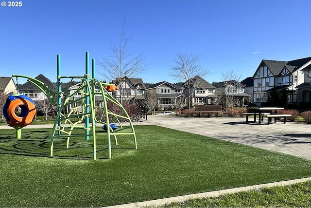 community jungle gym featuring a residential view and a yard