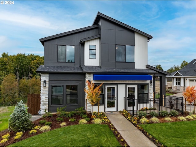 contemporary home with a front lawn