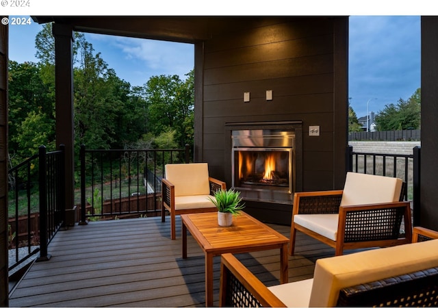 wooden terrace featuring an outdoor living space with a fireplace