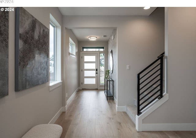 entryway featuring a wealth of natural light and light hardwood / wood-style floors