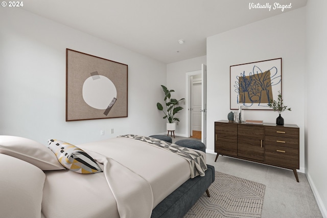 bedroom featuring light colored carpet and baseboards