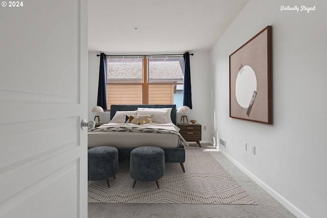 carpeted bedroom featuring visible vents and baseboards