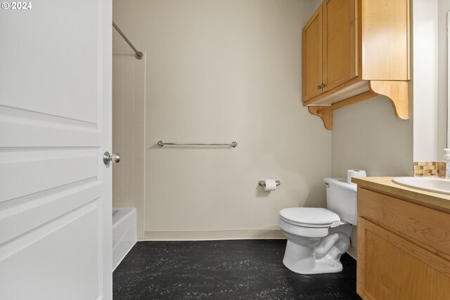 full bathroom with tiled shower / bath, vanity, and toilet