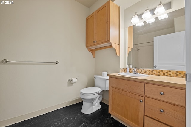 bathroom featuring toilet, tasteful backsplash, and vanity