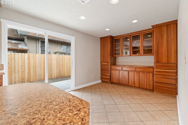 kitchen with light tile patterned flooring and a textured ceiling