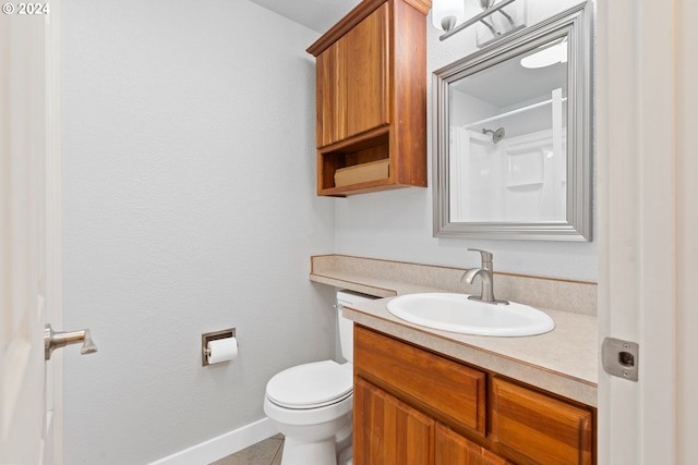 bathroom featuring tile patterned flooring, vanity, and toilet