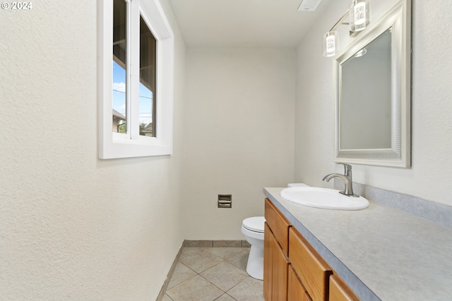 bathroom featuring tile patterned floors, vanity, and toilet