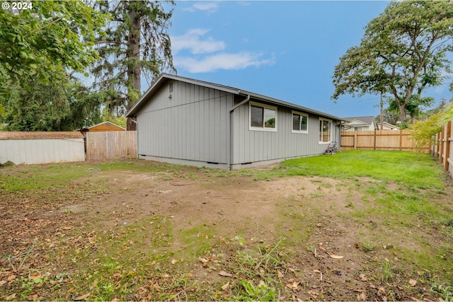 rear view of property with a yard