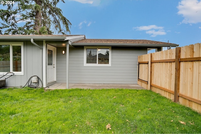 rear view of house with a yard