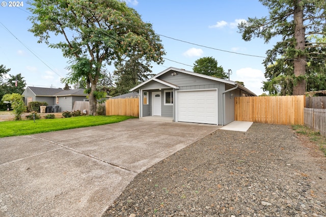 ranch-style house featuring a front lawn and a garage