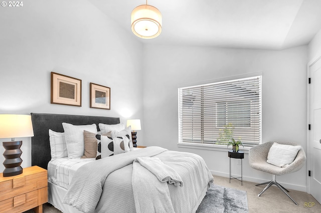 carpeted bedroom with vaulted ceiling