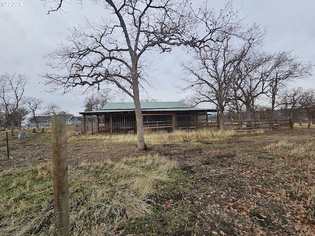 rear view of house featuring an outbuilding