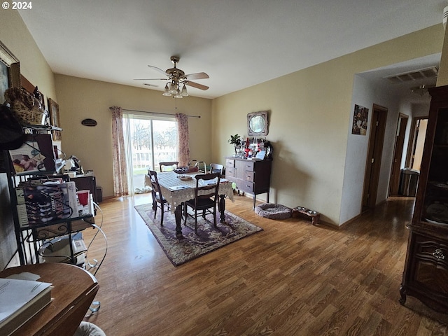 dining area with hardwood / wood-style flooring and ceiling fan