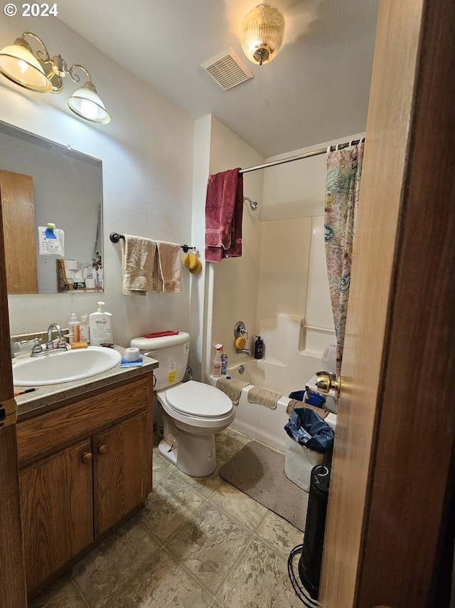 full bathroom with vanity, shower / tub combo, and toilet