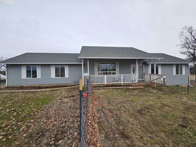 single story home with a porch and a front lawn