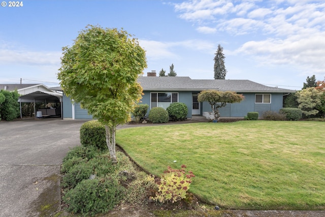 ranch-style house with a garage, a front lawn, and a carport