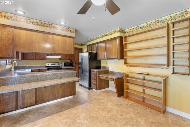 kitchen featuring exhaust hood, kitchen peninsula, stainless steel appliances, sink, and ceiling fan