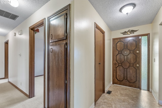 entrance foyer with a textured ceiling