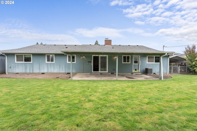 rear view of property with a patio, a yard, and central air condition unit