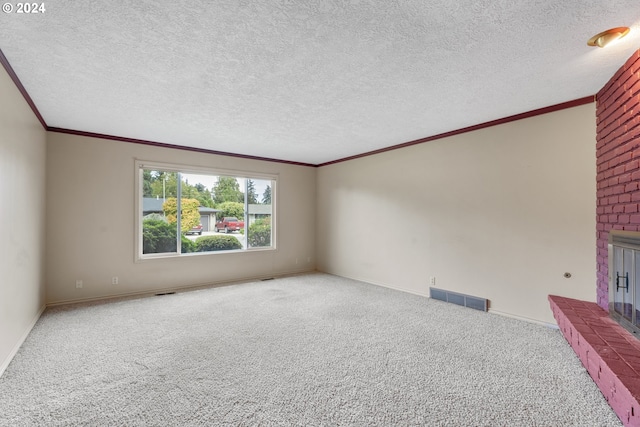 unfurnished room with ornamental molding, a textured ceiling, a fireplace, and carpet floors