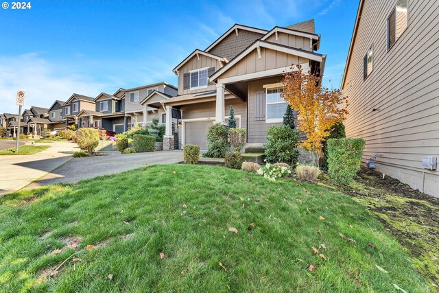 view of front of home with a garage and a front lawn