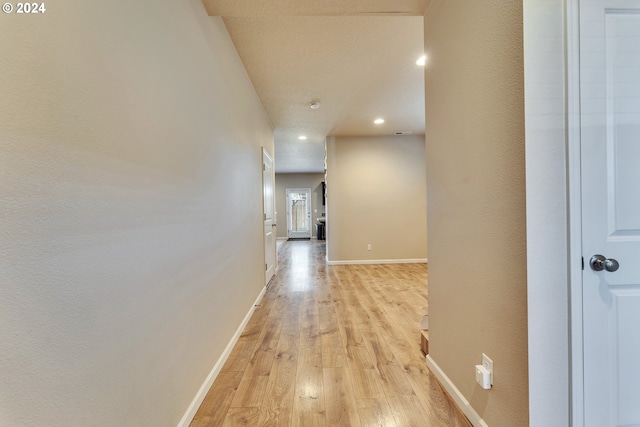 hallway with light hardwood / wood-style flooring