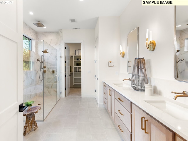 bathroom with tile patterned flooring, an enclosed shower, and vanity