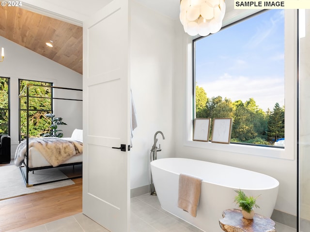 bathroom featuring wood ceiling, plenty of natural light, and a washtub