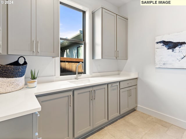 kitchen featuring sink and gray cabinetry