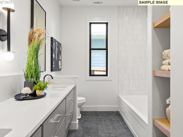 bathroom featuring toilet and vanity