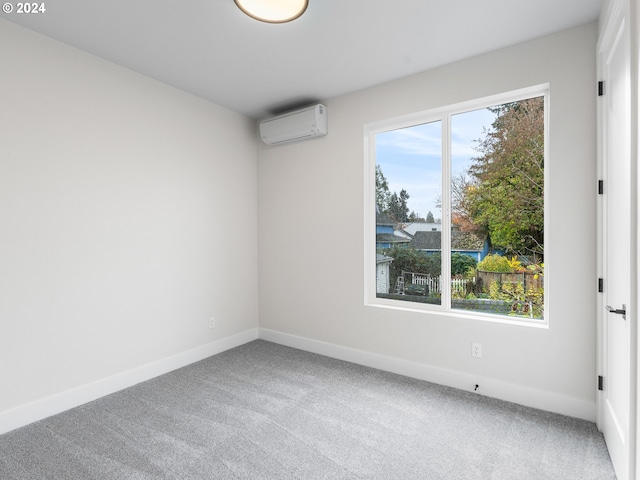 carpeted spare room featuring an AC wall unit