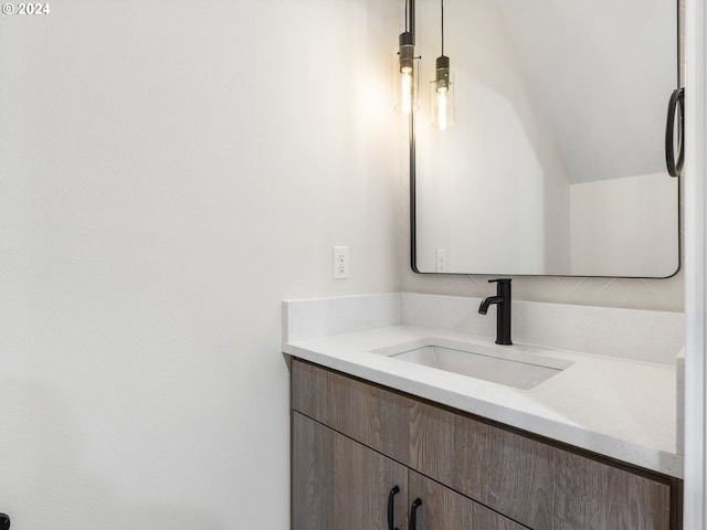 bathroom with vanity and vaulted ceiling