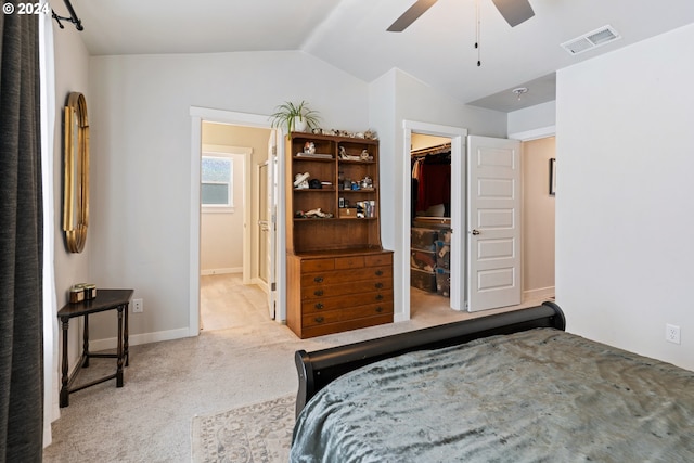 carpeted bedroom with a spacious closet, a closet, ceiling fan, and lofted ceiling