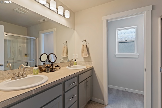 bathroom featuring vanity and a shower with door