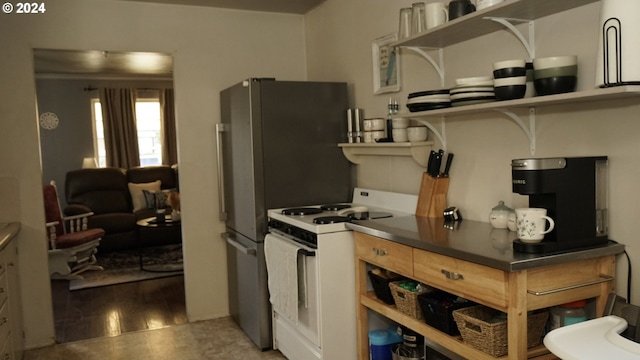 kitchen featuring white range with gas cooktop and light hardwood / wood-style flooring