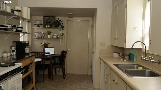 kitchen featuring sink and white cabinets