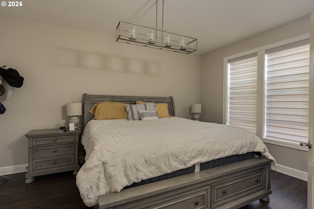 bedroom with dark hardwood / wood-style flooring