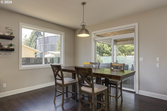 dining space with dark hardwood / wood-style flooring