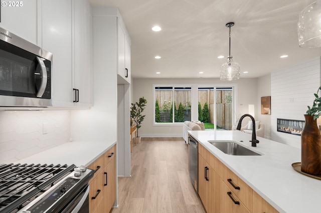12020 SW Trask St Unit Lt95, Beaverton, OR 97007 - kitchen featuring appliances with stainless steel finishes, recessed lighting, light wood-style floors, light countertops, and tasteful backsplash