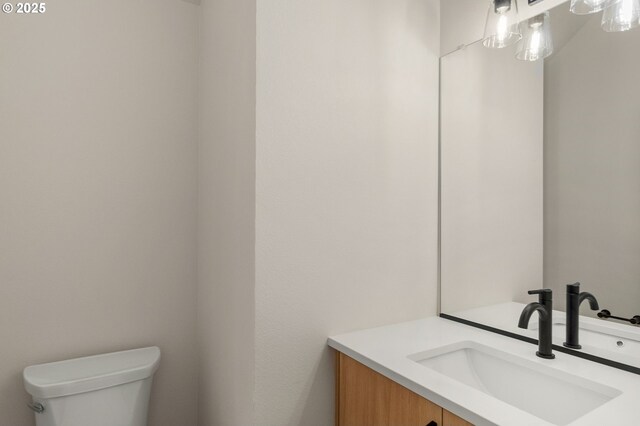 bathroom with toilet and vanity