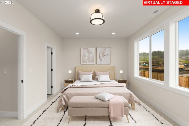 bedroom featuring recessed lighting, light carpet, and baseboards